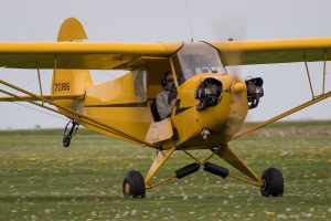 Tailwheel aircraft at Hartford, WI airport. Close up of Tom Hegy in his  biplane with Erin.